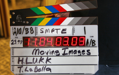 A film making clapperboard that says SMPTE Moving Images, H. Lukk, T. LaBalla.