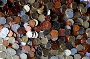 A large pile of various coins from various countries.