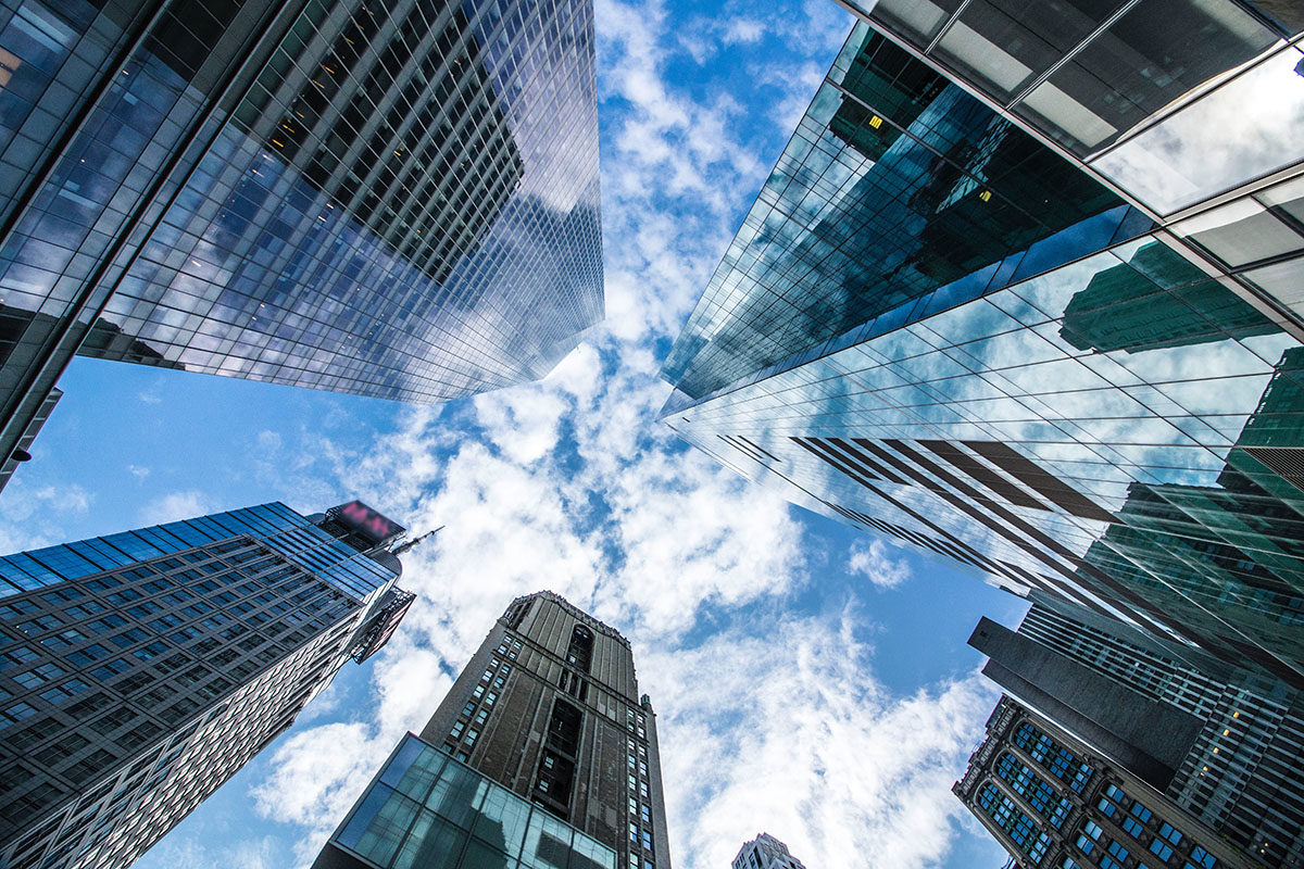 Skyscrapers seen from below with the sky above them.