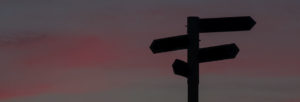 The silhoutte of a street sign at dusk.