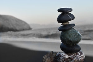 Smooth stones stacked up on a beach.