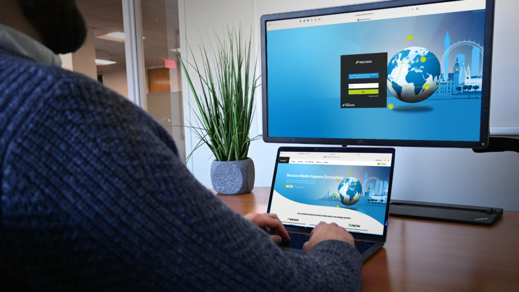 Person at desk with laptop and monitor on Signiant's website